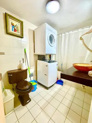a bathroom with a toilet and a sink and a microwave at Ocean View Nice and cozy in Lima