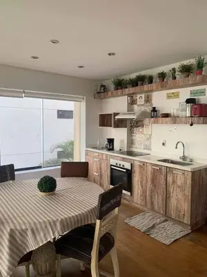 a kitchen with a table and a kitchen with a sink at Ocean View Nice and cozy in Lima