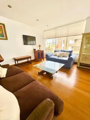 a living room with a couch and a table at Ocean View Nice and cozy in Lima