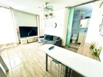 a living room with a couch and a tv at Flat between Barranco, Miraflores & Surco in Lima