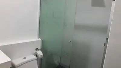 a bathroom with a glass shower and a toilet at Eurocasas Villa Velarde in Lima