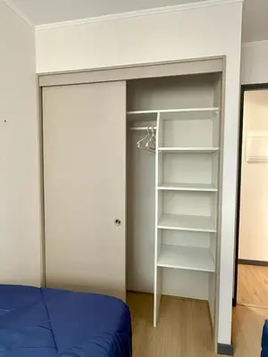 a bedroom with a bed and a closet at Departamento Style in Lima