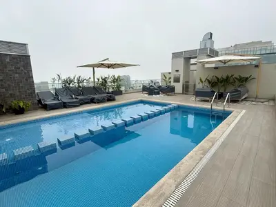 a swimming pool on the roof of a building at Departamento Style in Lima