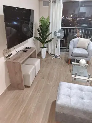 a living room with a large television and a couch at Modern apartment with great view in Lima in Lima
