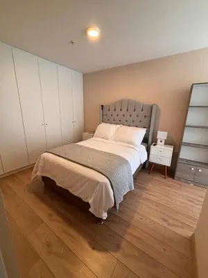 a bedroom with a large bed and a wooden floor at Modern apartment with great view in Lima in Lima