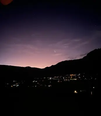 a view of a city at night with mountains at Casa Divina Medicina in Urubamba