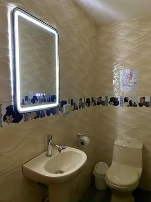 a bathroom with a sink and a toilet and a mirror at Hotel Naciones Unidas in Lima