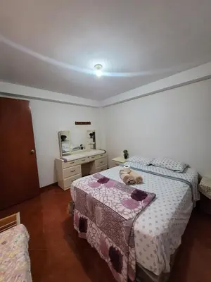 a bedroom with a bed with a teddy bear on it at Habitación privada cerca del aeropuerto in Lima