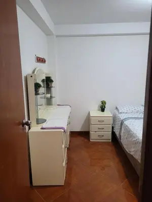 a bedroom with two beds and a mirror in it at Habitación privada cerca del aeropuerto in Lima