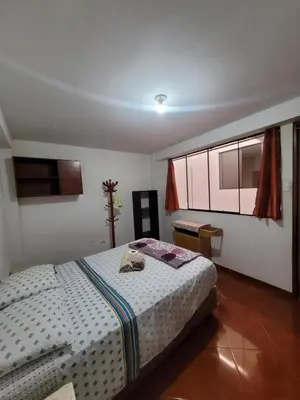 a bedroom with a bed and a window in it at Habitación privada cerca del aeropuerto in Lima