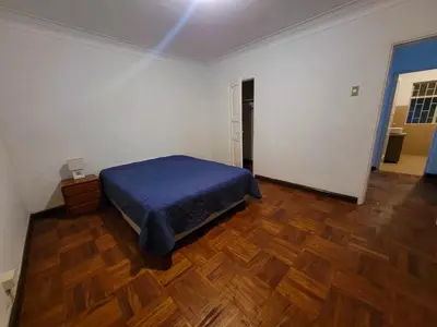 a bedroom with a bed and a wooden floor at Comfy Rooms in a Cozy House - Miraflores in Lima