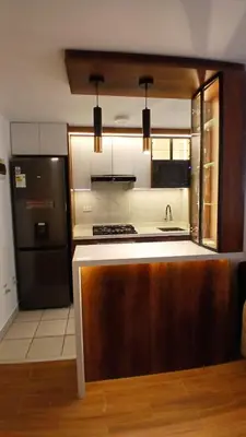 a kitchen with a sink and a black refrigerator at Departamento amoblado y Estacionamiento Gratis in Lima