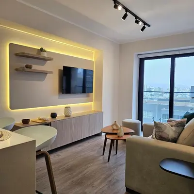 a living room with a couch and a tv at Modern Brand New Apartment in Miraflores in Lima
