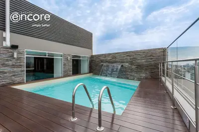 a swimming pool on the balcony of a building at Ramada Encore by Wyndham Lima San Isidro in Lima