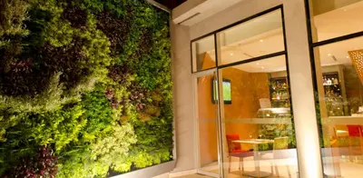 a green wall in front of a store at Ramada Encore by Wyndham Lima San Isidro in Lima