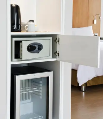 a room with a microwave oven and a bed at Ramada Encore by Wyndham Lima San Isidro in Lima