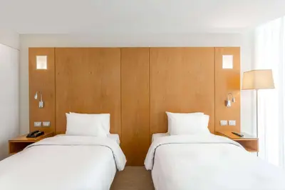 two beds sitting next to each other in a room at Ramada Encore by Wyndham Lima San Isidro in Lima