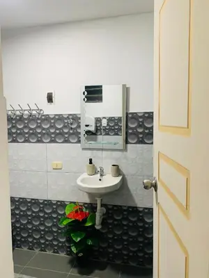 a bathroom with a sink and a mirror at HOSPEDAJE don VICTOR