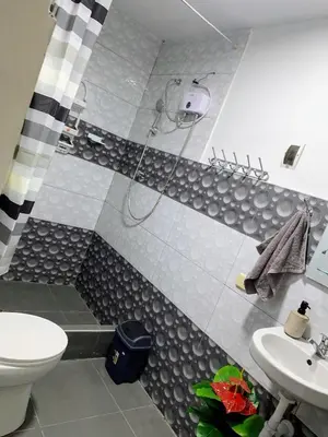 a bathroom with a shower and a toilet and a sink at HOSPEDAJE don VICTOR