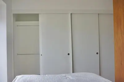 a white closet with four closets in a bedroom at Great New Studio in Barranco in Lima