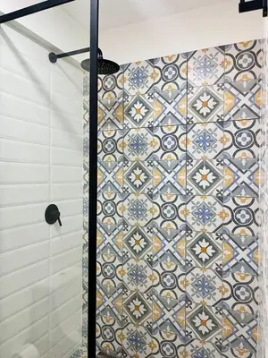 a shower with a mosaic tile wall in a bathroom at Great New Studio in Barranco in Lima