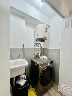 a small bathroom with a sink and a washing machine at Great New Studio in Barranco in Lima
