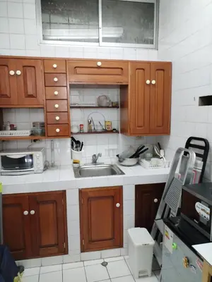 a kitchen with wooden cabinets and a sink at Miraflores Cozy Private Apartment with ocean view in Lima