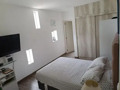 a bedroom with a bed and a flat screen tv at Maya House Cieneguilla in Cieneguilla
