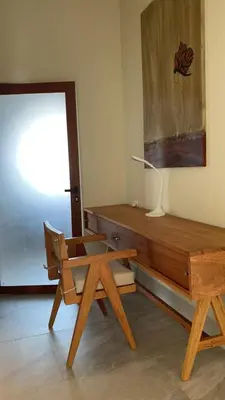 a room with a bench and a table and a lamp at Casa Campo-Playa Sand in My Shoes in Chincha