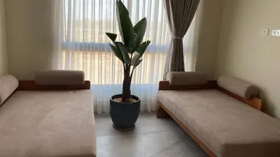 a room with two beds and a potted plant at Casa Campo-Playa Sand in My Shoes in Chincha