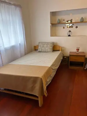 a small bedroom with a bed and a window at Valentino Vent in Cusco