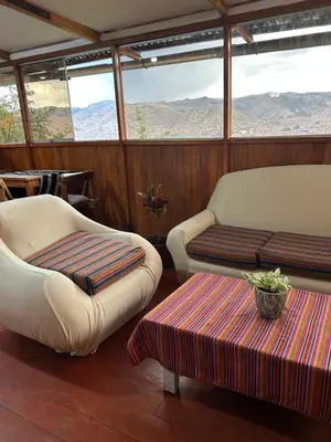 a living room with two chairs and a table at Valentino Vent in Cusco
