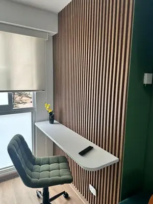 a desk and a chair in a room at Bertolotto, divino minidepa smartv wifi y amoblado in Lima