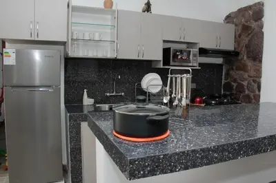 a kitchen with a large pot on a counter at Valle Sagrado Mágico in Urubamba