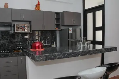 a kitchen with a red tea kettle on a counter at Valle Sagrado Mágico in Urubamba