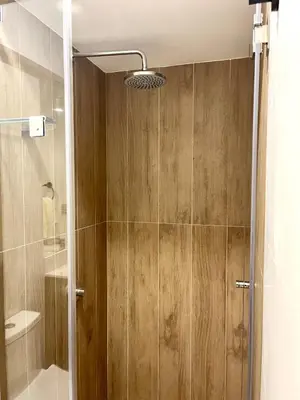 a shower with a glass door in a bathroom at Great 1BR in San Isidro in Lima