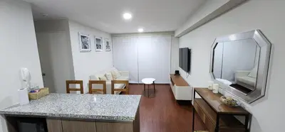 a living room with a counter and a mirror at Modern suite in San Miguel -Costa 21 in Lima