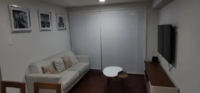 a living room with a couch and a tv at Modern suite in San Miguel -Costa 21 in Lima