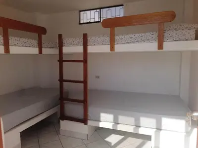 a bedroom with two bunk beds in a room at Casa de Playa en Lobos in Cerro Azul