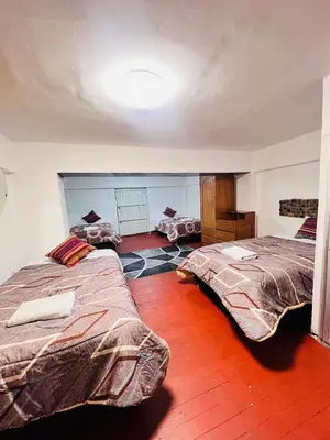 a bedroom with two beds in a room at SkyGuest Cusco San Cristobal in Cusco