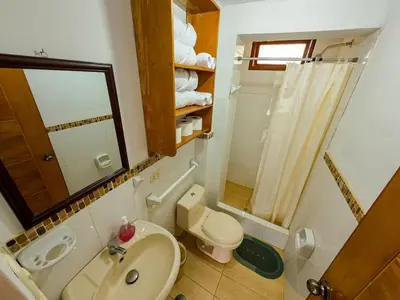 a bathroom with a toilet and a sink and a mirror at Fundo Venegas & Montoya in Jauja