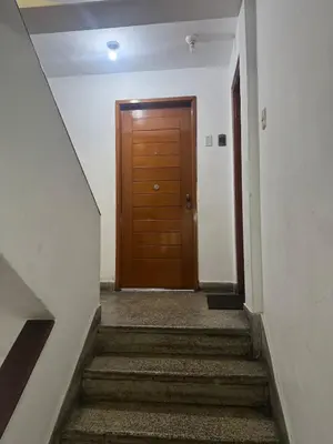 a hallway with a wooden door and stairs at Centrally located and comfortable duplex in Miraflores - Libertad1BR in Lima