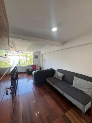 a living room with a couch and a table at Centrally located and comfortable duplex in Miraflores - Libertad1BR in Lima