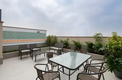 a patio with a table and chairs and plants at Katty's apartment - Santa Beatriz in Lima