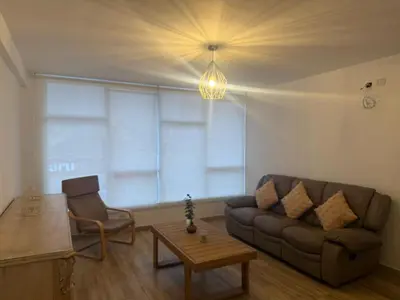 a living room with a couch and a table at Welcoming apartment in Lima
