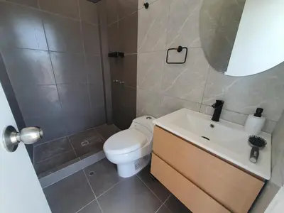 a bathroom with a toilet and a sink and a mirror at CASA PLAYA con PISCINA in Punta Negra