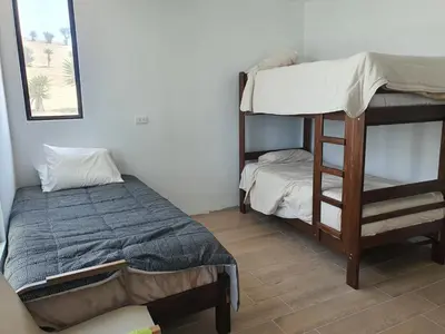 a bedroom with two bunk beds and a bed at CASA PLAYA con PISCINA in Punta Negra