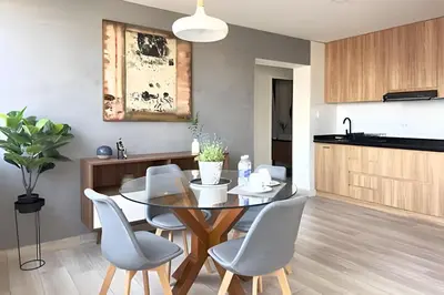 a kitchen and dining room with a table and chairs at The 28 Residence Miraflores in Lima