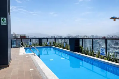 a swimming pool on the roof of a building at La Foret in Lima