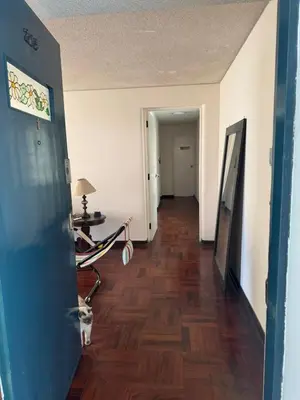 a hallway of an apartment with a hard wood floor at Miraflores, habitación en apartamento compartido in Lima